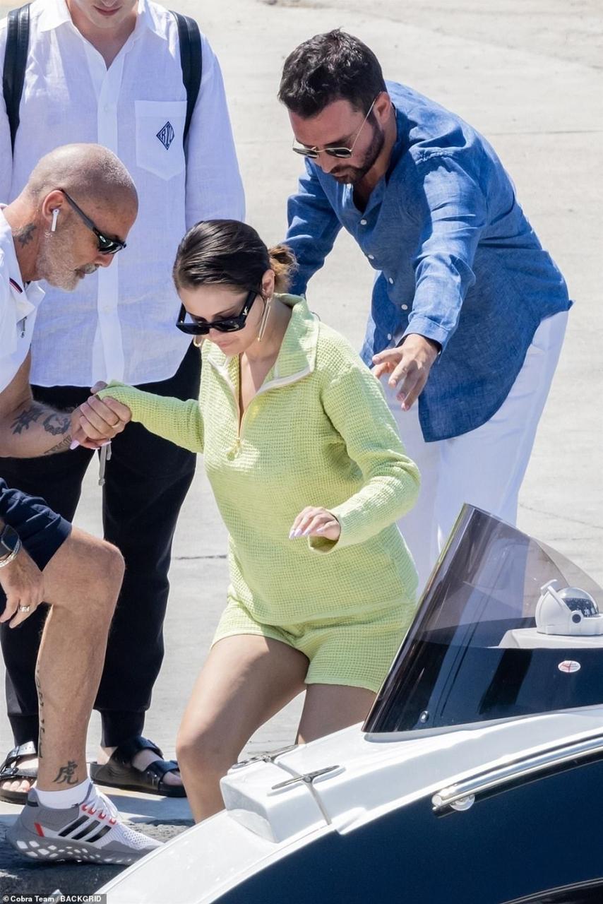 Keeping cool: Andrea opted for a blue linen shirt with a pair of white trousers