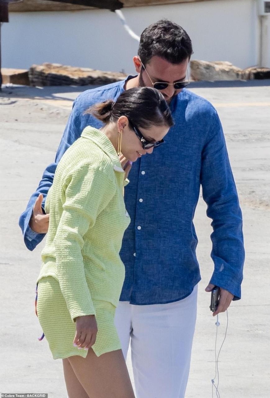 Gentleman: Andrea placed his hand on Selena's arm as he helped her into the boat