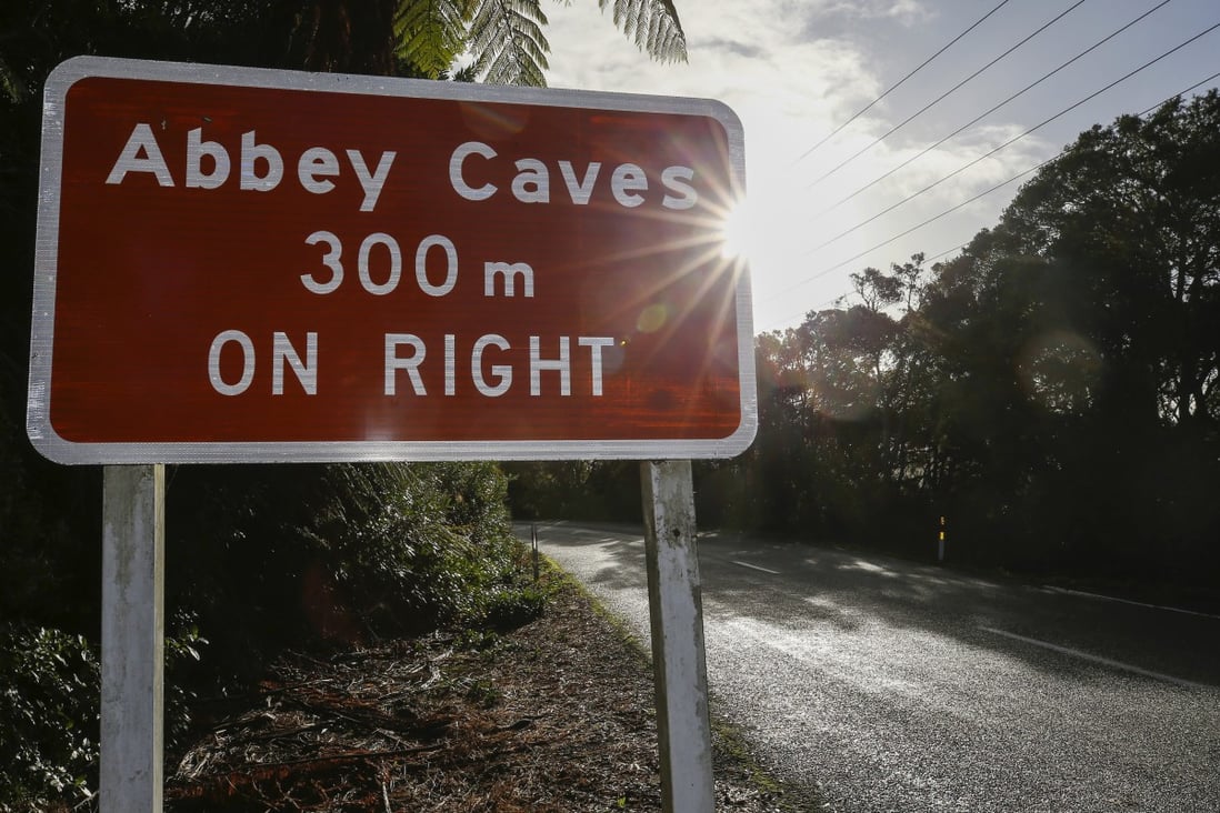 A sign is seen for Abbey Caves near the northern New Zealand city of Whangarei, where the student’s body was found following a flash flood. Photo: Northern Advocate via AP