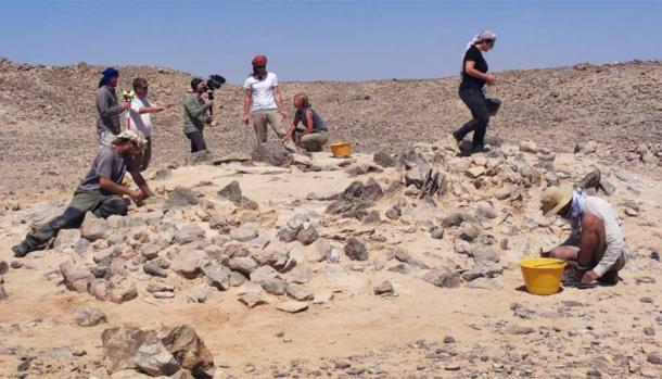 Archaeologists examine a stone monument, known as a trilith. (Roman Garba and Alžběta Danielisov/ Institute of Archaeology of the CAS in Prague)