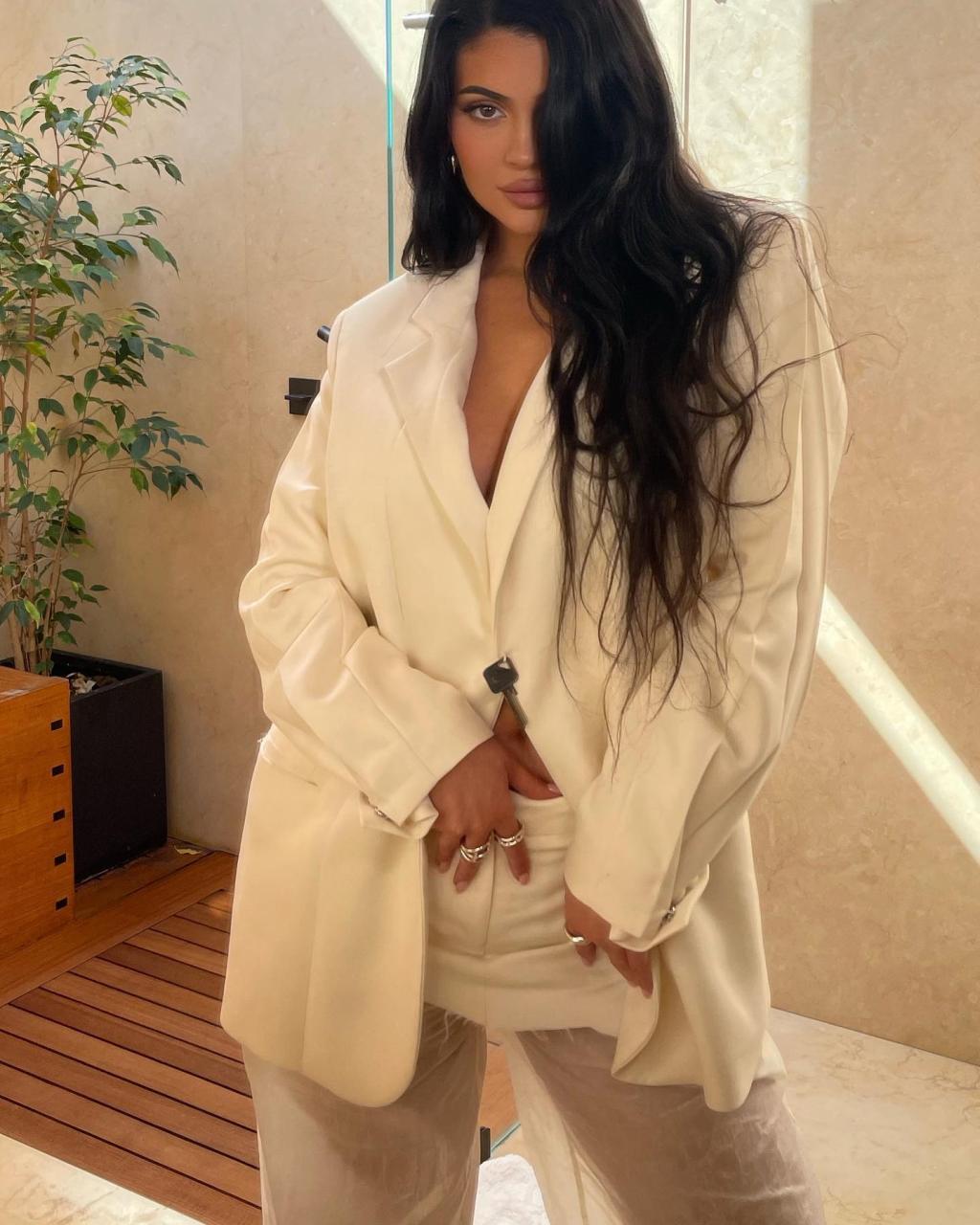 Kylie Jenner posed in a white blazer with NO bra the day of her new cosmetics line