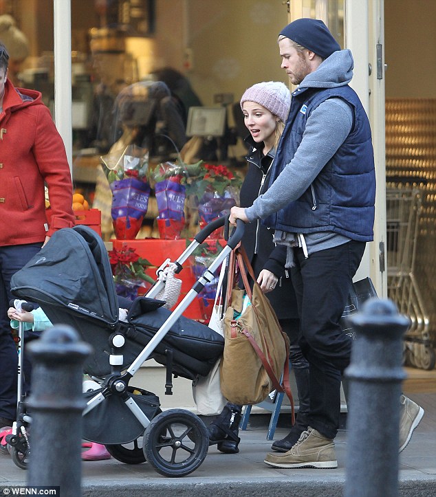 Not quite like the Californian sun: The couple were appropriately bundled up against the London chill