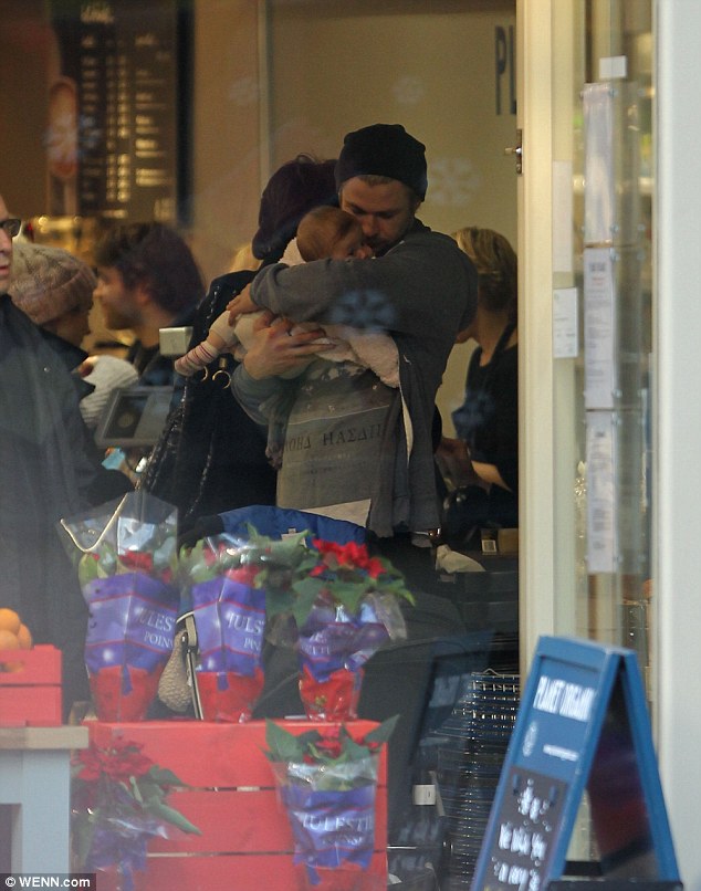 Daddy's little angel: Chris was seen giving India Rose a tender kiss on the cheeks while mum was getting the couple a hot drink