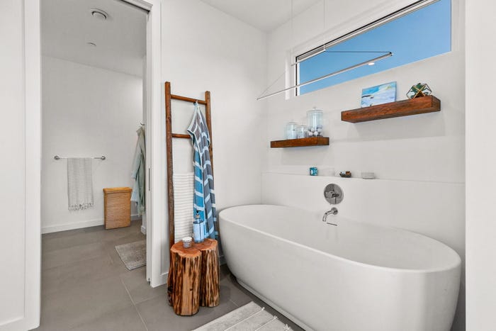 prefab home bathroom, round tub and brown wood features, dvele malibu