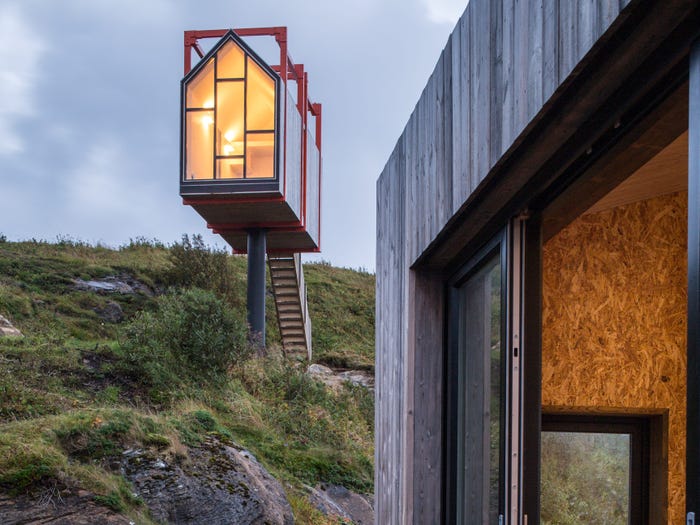 An outdoor deck attached to an arctic hideaway building