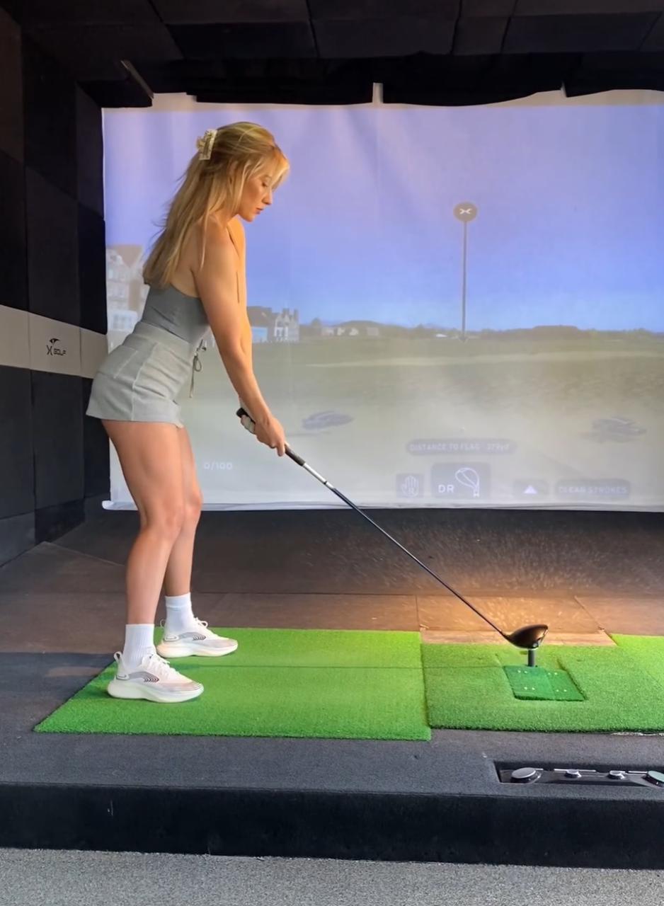 Accompany Paige Spiranac to the X-Golf Club and Observe Her Impressive Golf Stance 4